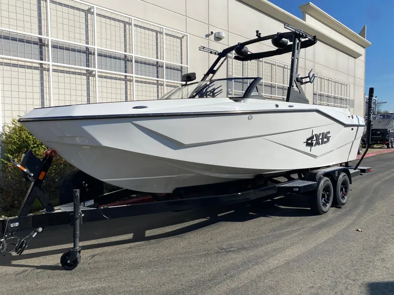 The Image of 2025 Axis T235 boat on trailer, parked outdoors, white exterior. - 0