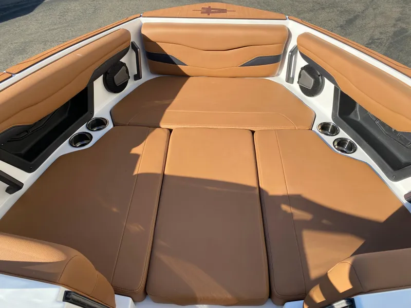 Slide: The Image of 2025 Axis T235 boat interior with tan leather seating and cup holders. - 10