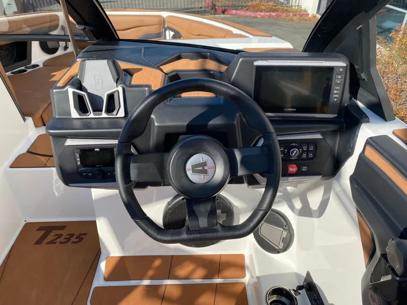 Slide: The Image of 2025 Axis T235 boat dashboard with steering wheel and digital display. - 11