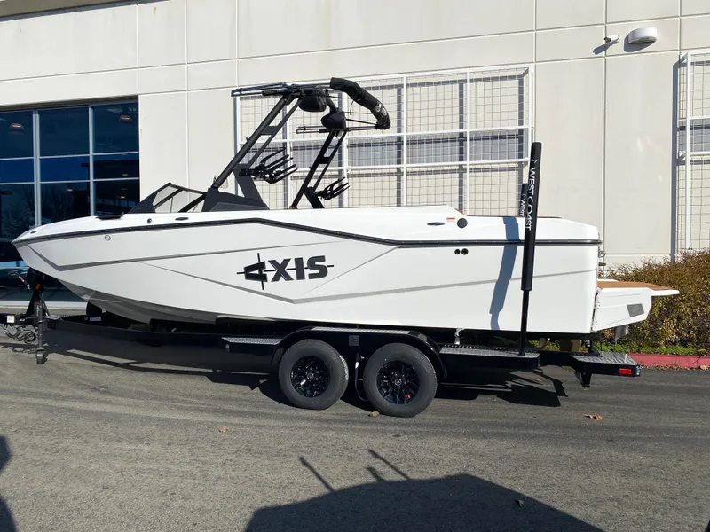 Slide: The Image of 2025 Axis T235 boat on trailer, parked outdoors, side view. - 2