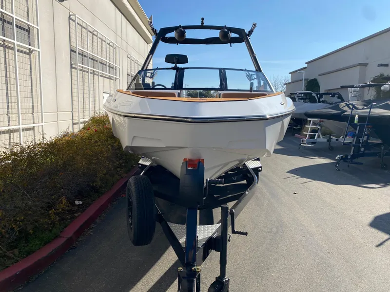 Slide: The Image of 2025 Axis T235 boat on trailer, parked outdoors in sunny setting. - 4