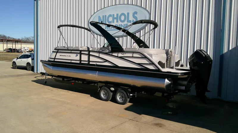 Slide: The Image of 2025 Bennington 25 QFB pontoon boat on trailer outside Nichols Marine. - 3