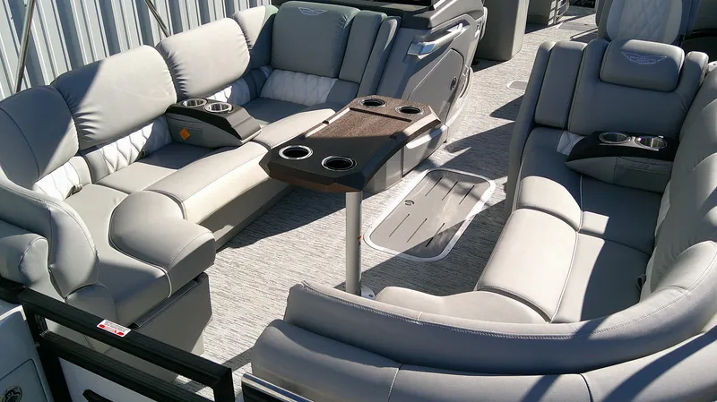 Slide: The Image of 2025 Bennington 25 QFB boat interior with luxurious seating and cup holders. - 4