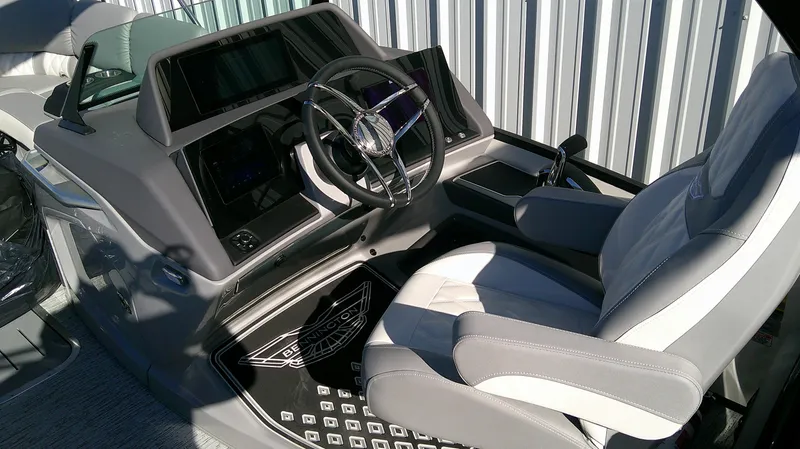 Slide: The Image of 2025 Bennington 25 QFB boat helm with modern steering and comfortable seating. - 6