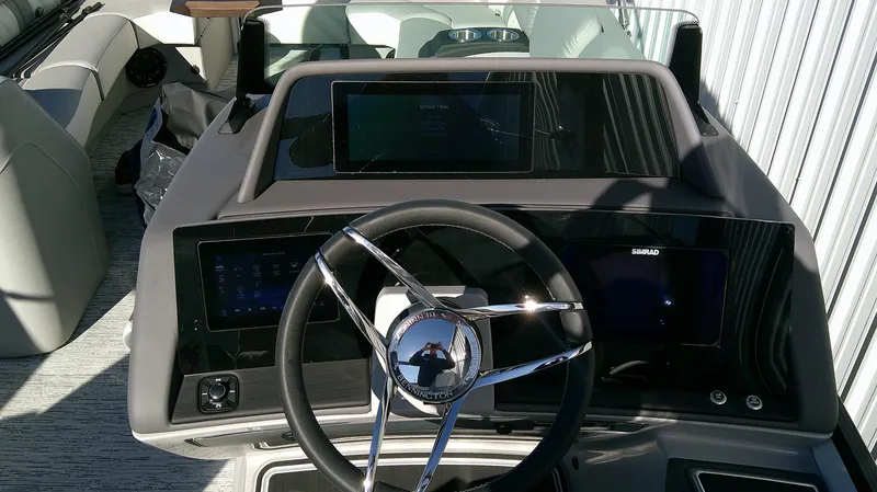 Slide: The Image of Steering console of 2025 Bennington 25 QFB boat with modern dashboard and controls. - 7