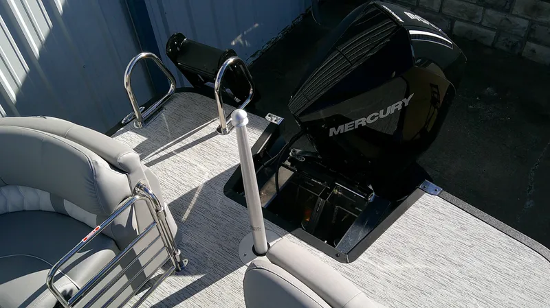 Slide: The Image of 2025 Bennington 25 QFB boat with Mercury engine, featuring sleek seating and modern design. - 9
