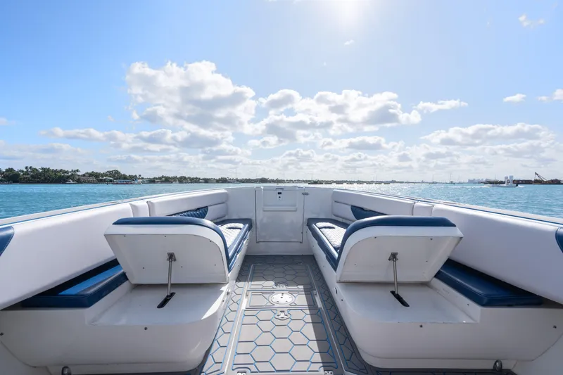 Slide: The Image of 2007 Intrepid 375 Center Console boat interior with blue seating on a sunny day. - 16