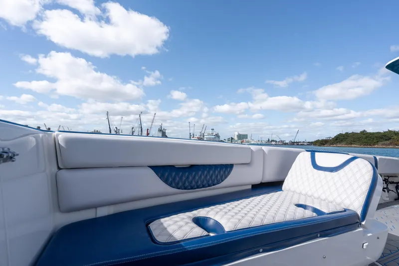 Slide: The Image of 2007 Intrepid 375 Center Console boat with blue and white seating, under a clear sky. - 18