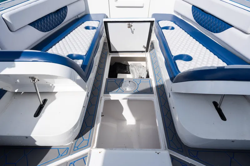 Slide: The Image of 2007 Intrepid 375 Center Console interior with blue and white seating and storage compartments. - 20