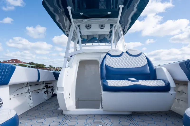 Slide: The Image of 2007 Intrepid 375 Center Console boat with blue and white seating under a clear sky. - 21