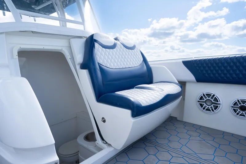 Slide: The Image of 2007 Intrepid 375 Center Console boat interior with blue and white seating and speakers. - 22