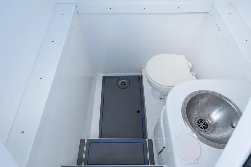 Slide: The Image of 2007 Intrepid 375 Center Console boat bathroom with toilet and sink. - 23