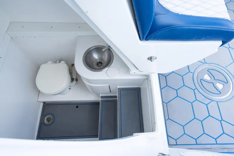 Slide: The Image of 2007 Intrepid 375 Center Console boat interior with sink and toilet. - 24