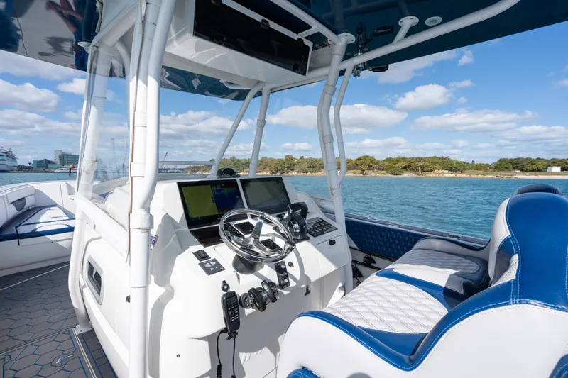 Slide: The Image of 2007 Intrepid 375 Center Console boat interior with steering wheel, navigation screens, and blue seating. - 28