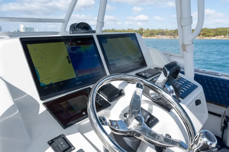 Slide: The Image of 2007 Intrepid 375 Center Console helm with dual navigation screens and steering wheel. - 30