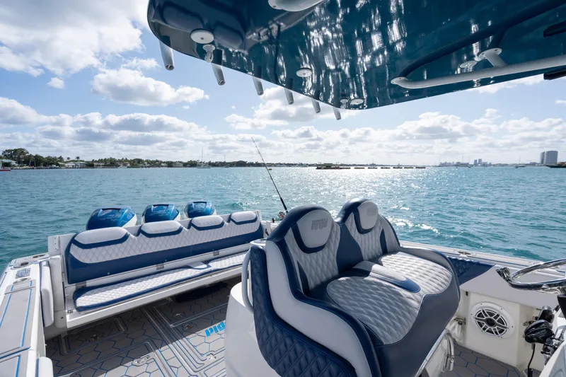 Slide: The Image of 2007 Intrepid 375 Center Console boat interior with seating, overlooking a sunny ocean view. - 33