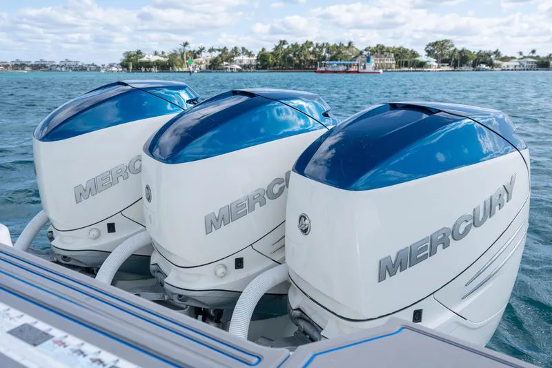 Slide: The Image of Triple Mercury outboard engines on a 2007 Intrepid 375 Center Console boat, cruising on blue waters. - 36
