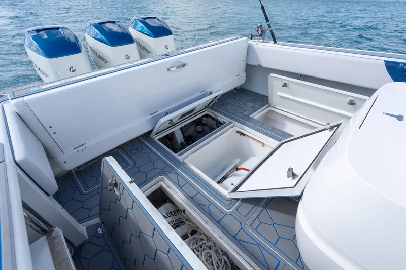 Slide: The Image of 2007 Intrepid 375 Center Console boat with open storage compartments and triple engines. - 37
