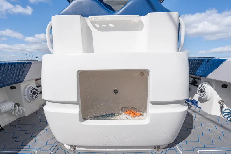 Slide: The Image of 2007 Intrepid 375 Center Console boat interior with storage compartment, blue accents, and speakers. - 38