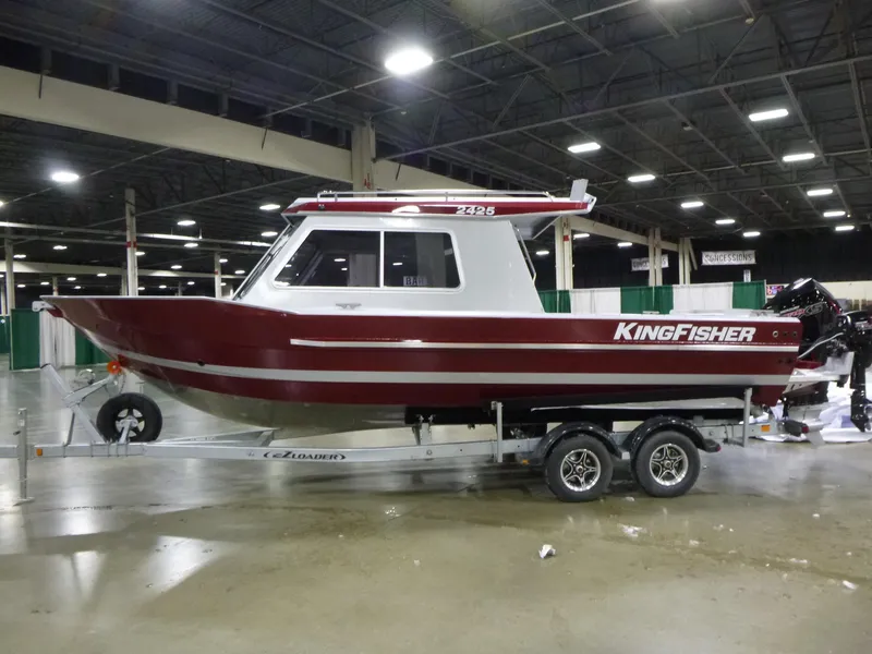 Slide: The Image of 2025 KingFisher 2425 Escape HT boat on trailer in indoor showroom. - 0