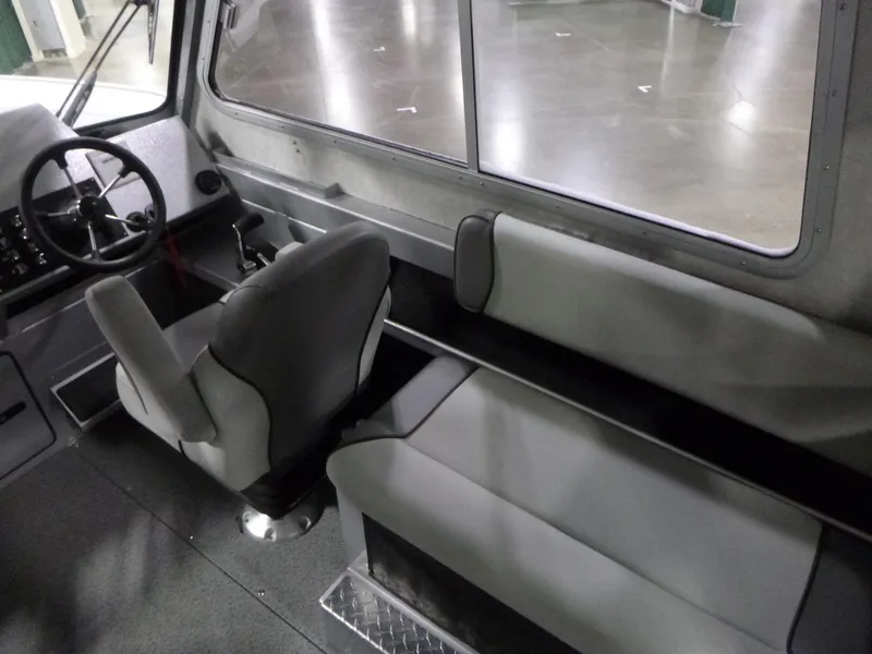 Slide: The Image of Interior of 2025 KingFisher 2425 Escape HT boat, featuring seating and steering area. - 10