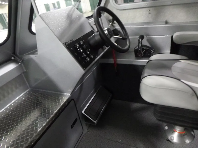Slide: The Image of Interior of 2025 KingFisher 2425 Escape HT boat, featuring steering wheel and seating. - 12