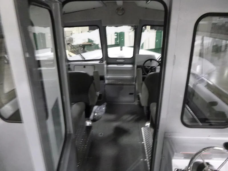Slide: The Image of Interior of 2025 KingFisher 2425 Escape HT boat, showcasing seating and helm area. - 13