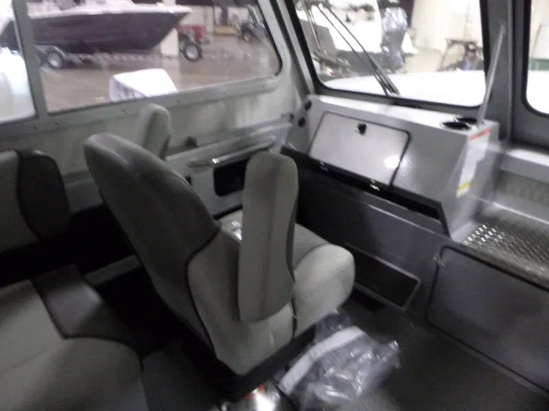 Slide: The Image of Interior of 2025 KingFisher 2425 Escape HT boat, featuring seating and control panel. - 14