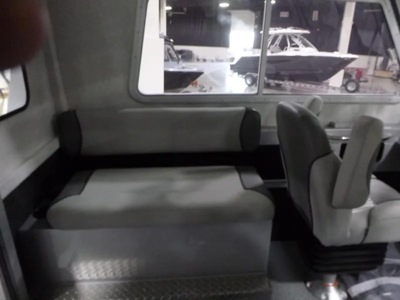 Slide: The Image of Interior of 2025 KingFisher 2425 Escape HT boat, featuring seating and window view. - 15