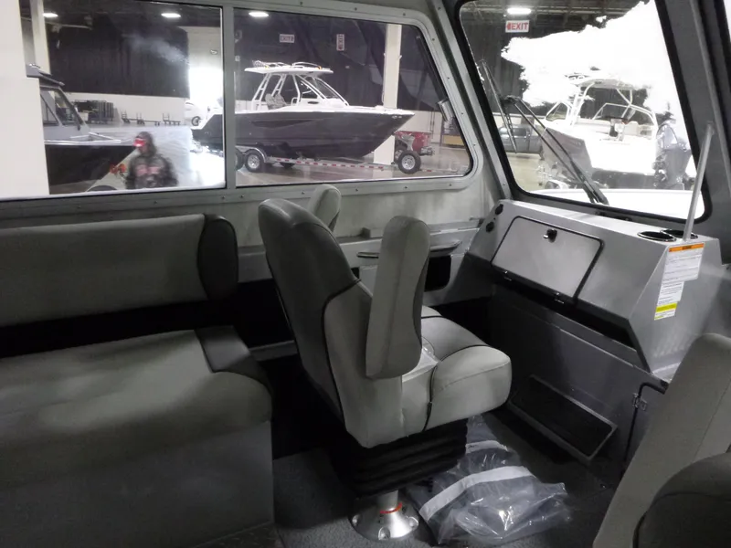 Slide: The Image of Interior of 2025 KingFisher 2425 Escape HT boat, featuring seating and dashboard. - 16