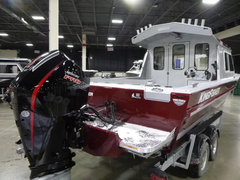 Slide: The Image of 2025 KingFisher 2425 Escape HT boat with powerful outboard motor in indoor showroom. - 22