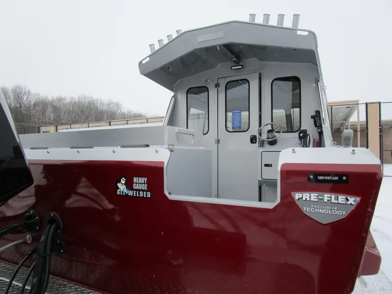 Slide: The Image of 2025 KingFisher 2425 Escape HT boat with Pre-Flex technology, red exterior, snowy background. - 29