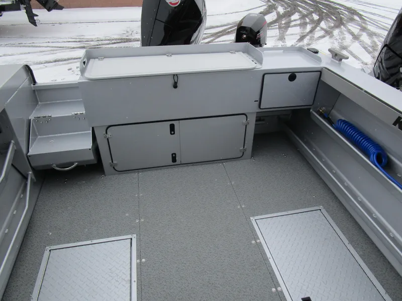 Slide: The Image of 2025 KingFisher 2425 Escape HT boat interior with storage compartments and non-slip flooring. - 32