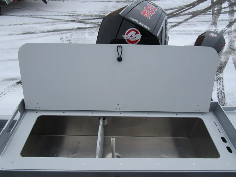 Slide: The Image of KingFisher 2425 Escape HT 2025 boat with open storage compartment and Mercury engine. - 34