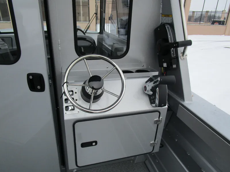 Slide: The Image of Steering console of 2025 KingFisher 2425 Escape HT boat, featuring modern controls. - 38