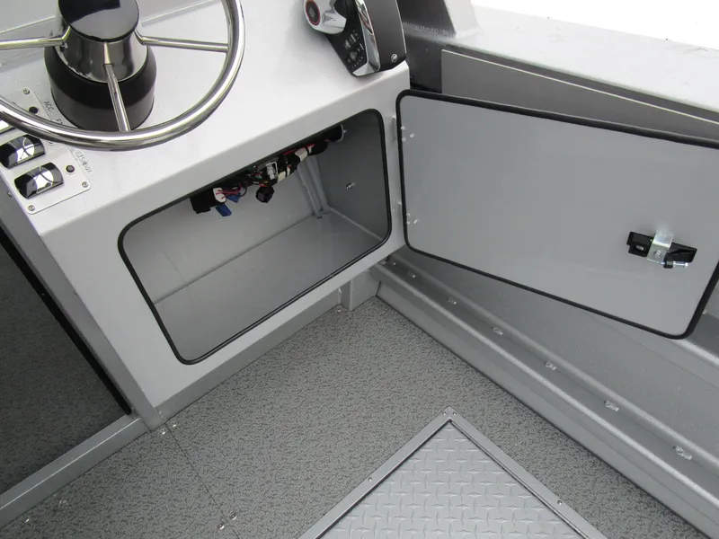 Slide: The Image of 2025 KingFisher 2425 Escape HT boat interior, featuring open storage compartment and steering wheel. - 39