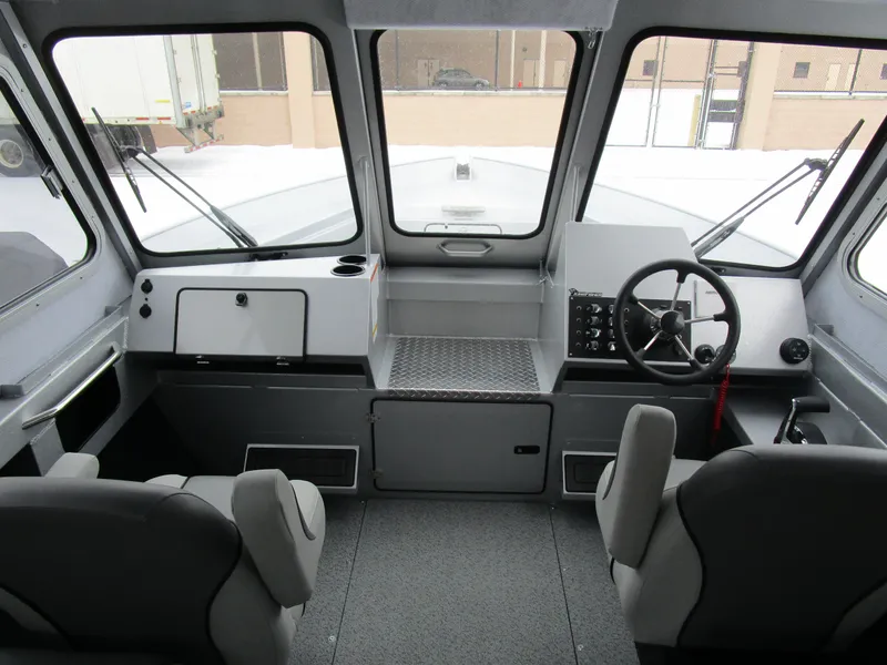 Slide: The Image of Interior of 2025 KingFisher 2425 Escape HT boat, featuring steering wheel and seating. - 40