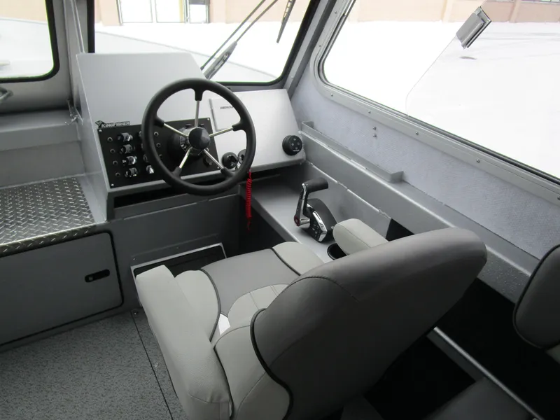 Slide: The Image of Interior of 2025 KingFisher 2425 Escape HT boat, featuring steering wheel and control panel. - 42