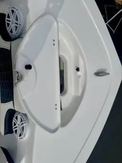 Slide: The Image of 2025 Tidewater 210 LXF boat deck with speakers and storage compartment. - 11