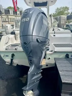 Slide: The Image of 2025 Tidewater 210 LXF boat with Yamaha 150 outboard motor, docked outdoors. - 14