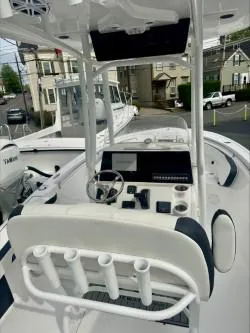 Slide: The Image of 2025 Tidewater 210 LXF boat interior with steering console and rod holders. - 3