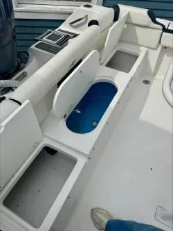 Slide: The Image of 2025 Tidewater 210 LXF boat interior with open storage compartments and livewell. - 8