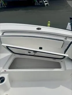 Slide: The Image of 2025 Tidewater 210 LXF boat storage compartment open on deck. - 9