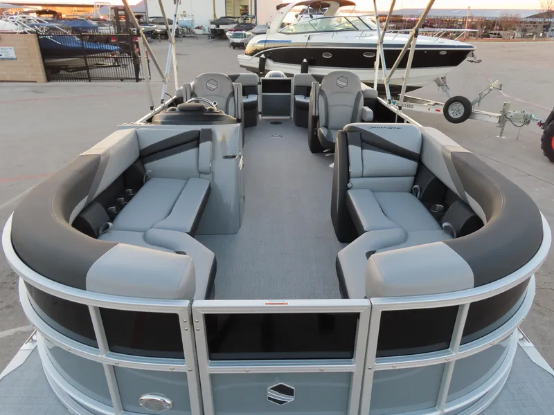 Slide: The Image of 2024 South Bay 224 RS 2.75 pontoon boat interior with spacious seating and modern dashboard. - 2