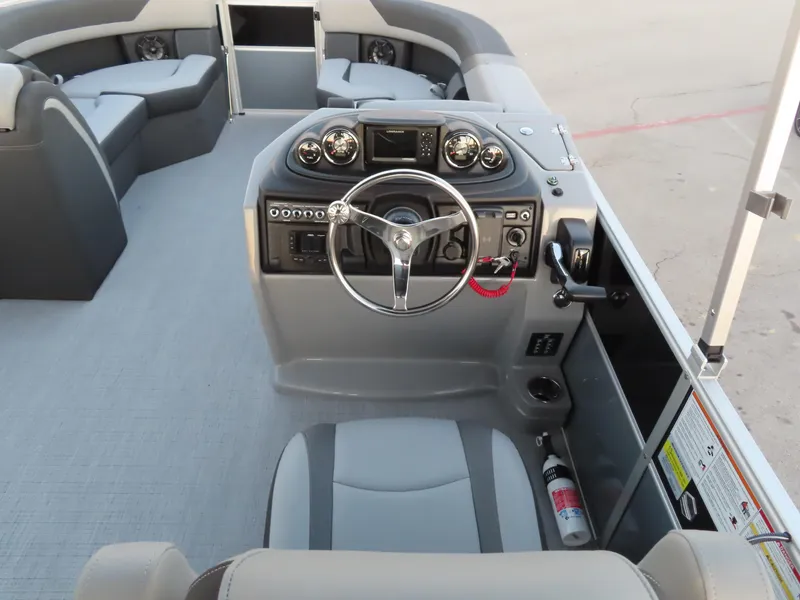 Slide: The Image of 2024 South Bay 224 RS 2.75 boat helm with gray captain's chair and steering wheel. - 6
