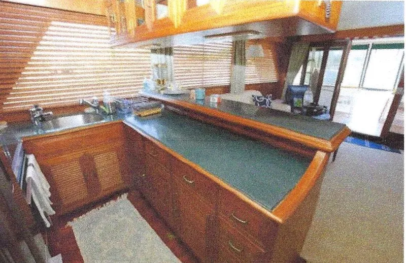 Slide: The Image of 1984 Ocean Alexander Flying Bridge Motor Yacht interior with wooden cabinetry and countertops. - 12