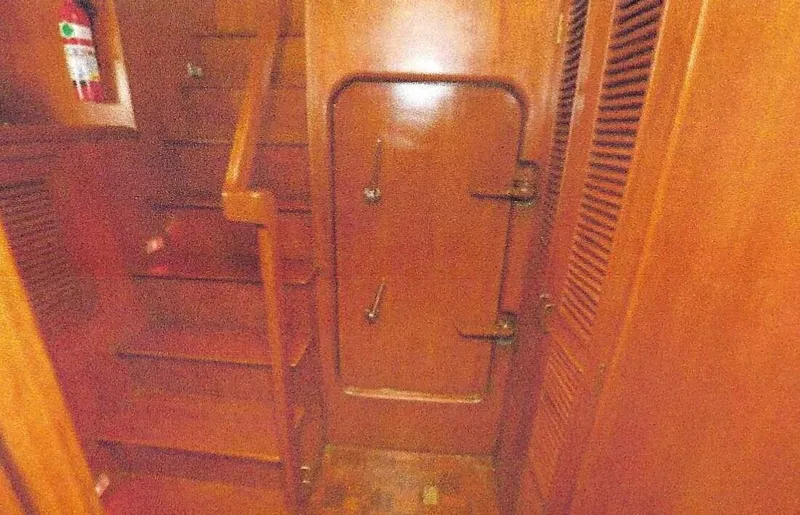 Slide: The Image of 1984 Ocean Alexander Flying Bridge Motor Yacht interior with wooden stairs and door. - 17
