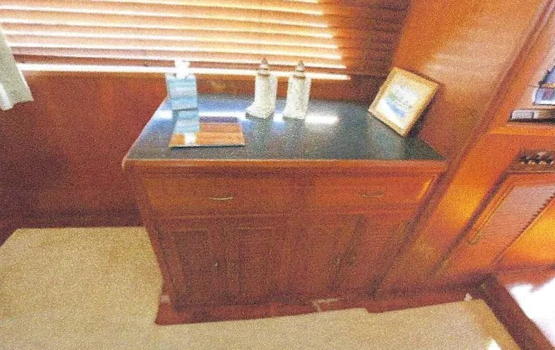 Slide: The Image of 1984 Ocean Alexander Flying Bridge Motor Yacht interior with wooden cabinetry and decor. - 18