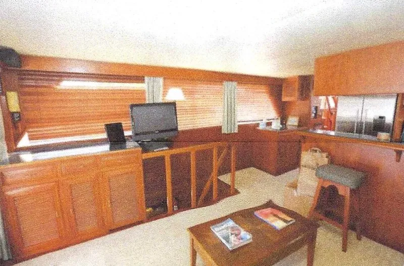 Slide: The Image of 1984 Ocean Alexander Flying Bridge Motor Yacht interior with wood paneling and modern amenities. - 19