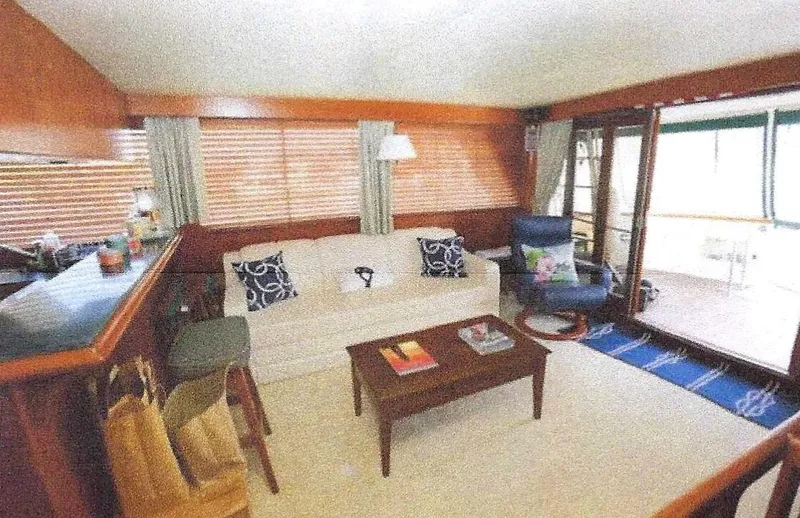 Slide: The Image of 1984 Ocean Alexander Flying Bridge Motor Yacht interior with cozy seating and wooden accents. - 21